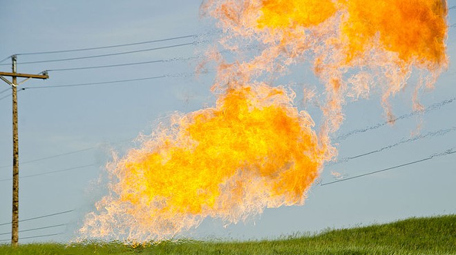 Natural gas burns from the flare-head of an oil well.