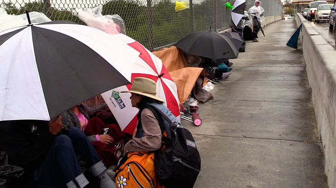 Central American refugees line up in Matamoros to wait for a chance to plead for asylum.