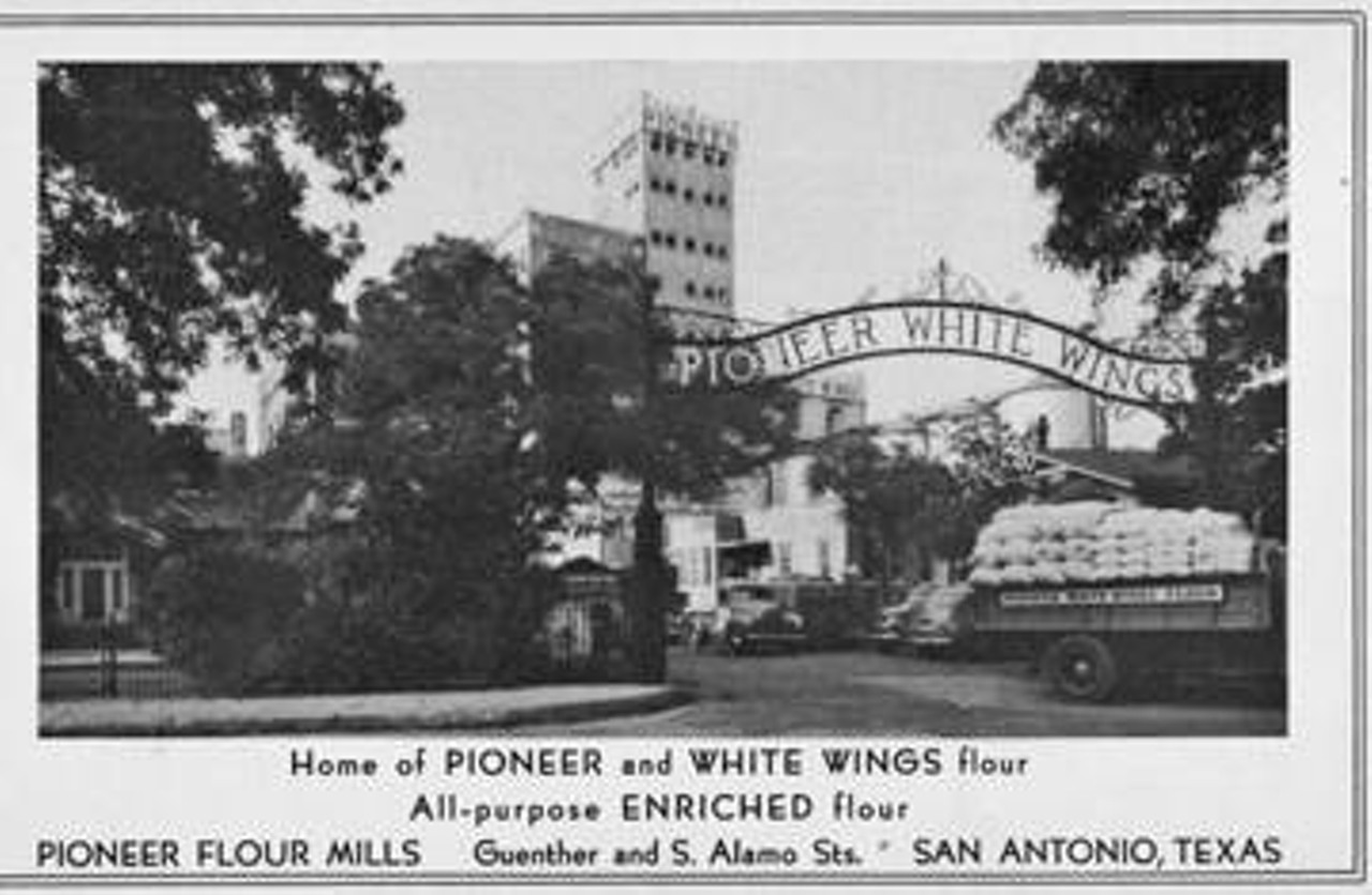 Pioneer Flour Mills, 1948
Photograph shows north entrance gate, mill in background, Guenther house on far left.