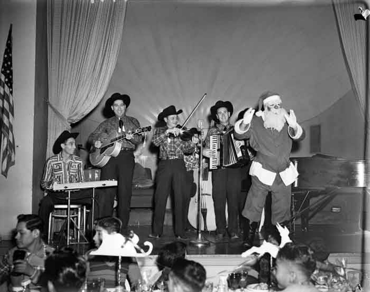 The Texas Top Hands and Santa Claus provided the entertainment for the annual Newsboys' Christmas Dinner in Crystal Ballroom of the Gunter Hotel in 1948.