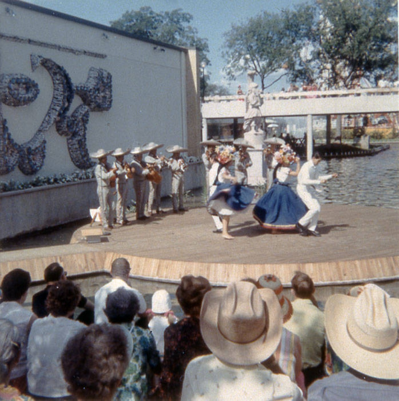 Audience watching mariachi group on floating stage outside Mexico Pavilion