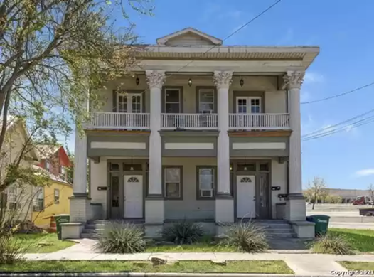 This fixer-upper for sale in central San Antonio has an amazing balcony and Greek-revival pillars
