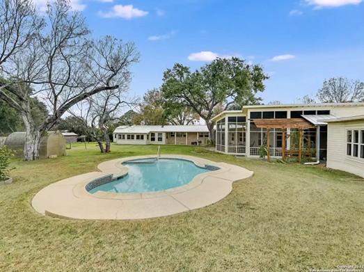 This Mid-Century Modern gem in Alamo Heights comes with olive trees and its own water well