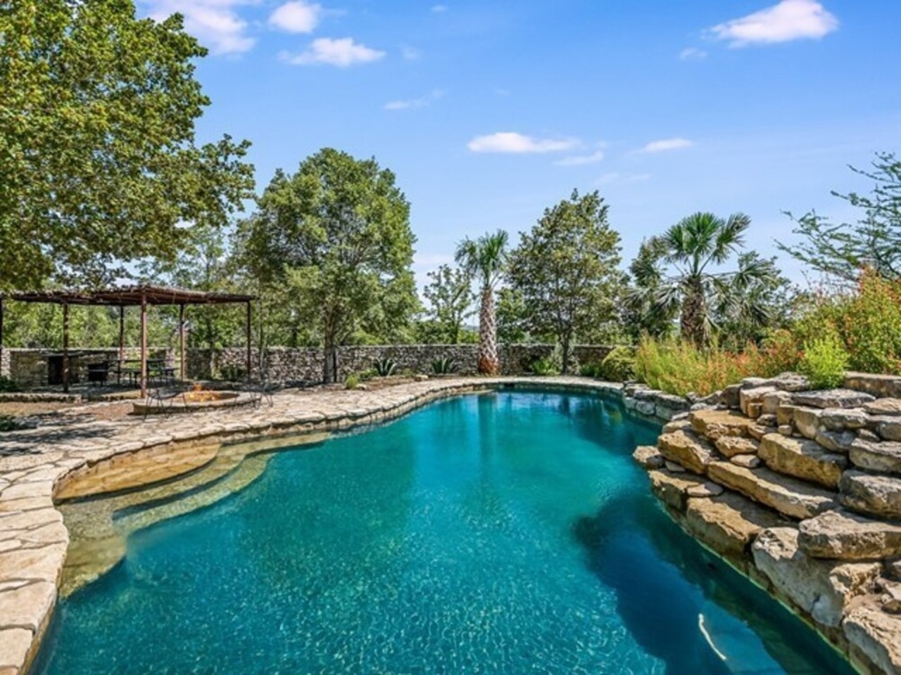 This Texas Hill Country mansion has a massive, 2-story glass atrium with a catwalk