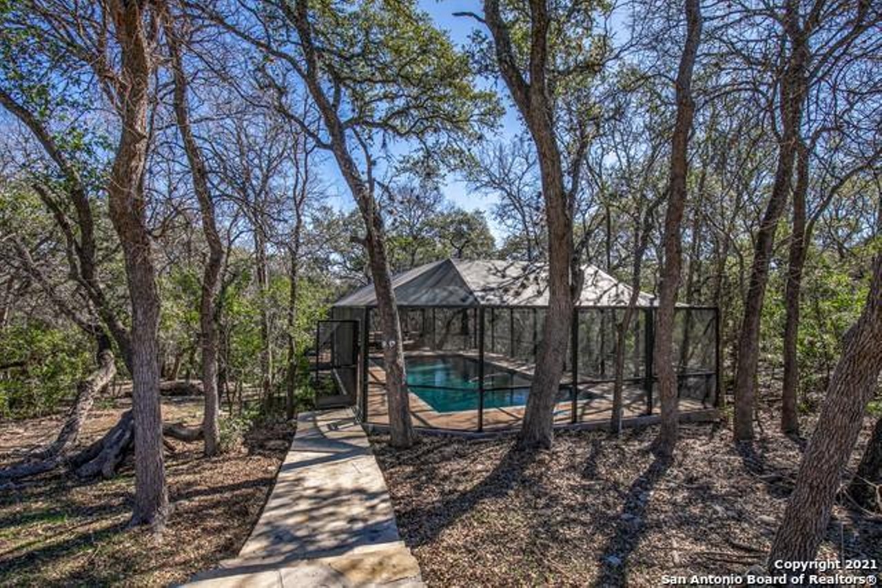 This West San Antonio home comes with a rare completely screened-in pool