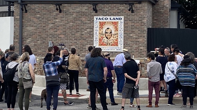 Taco Land regulars gather around a mosaic honoring the club's owner, the late Ram Ayala, on Thursday evening.
