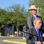 Analysis: Abbott's media event at San Antonio site for immigrant kids is political theater —&nbsp;of the absurd