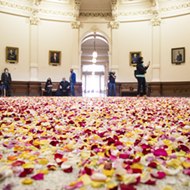 Activists blanket the Texas Capitol rotunda in rose petals to protest restrictive new voting bills