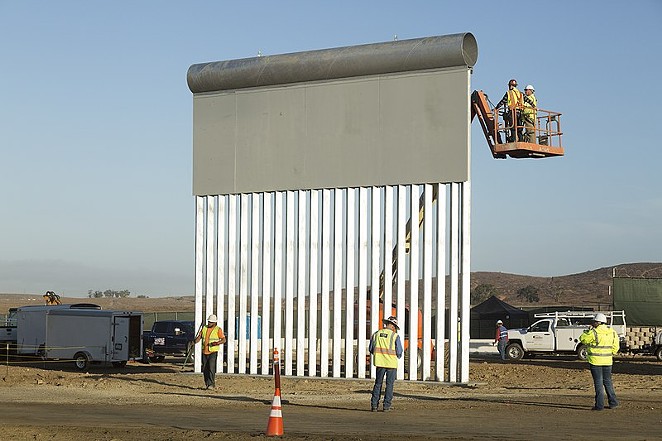 Workers construct a prototype of the proposed border wall near the Otay Mesa Port of Entry in San Diego. - MANI ALBRECHT (WIKIMEDIA COMMONS)