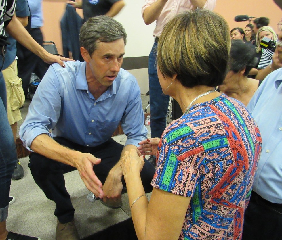 O’Rourke speaks to an audience member from the stage after the Corpus Christi town hall that drew more than 1,000 people. - SANFORD NOWLIN