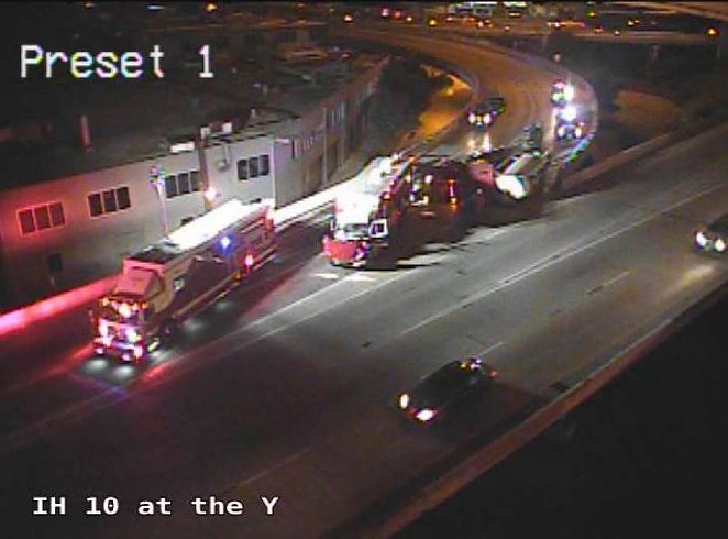 Emergency crews work to clear an overturned 18-wheeler at the Finesilver curve downtown. - TXDOT