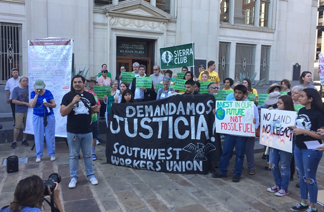Climate activists rally in front of San Antonio's council chambers on Wednesday evening. - Sanford Nowlin