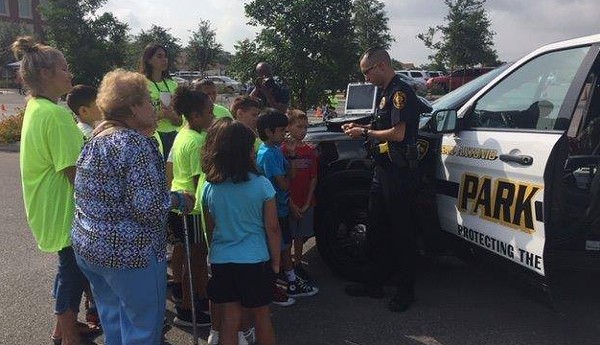 A park police officer shows off his patrol vehicle to visitors. - FACEBOOK / SAN ANTONIO PARK POLICE