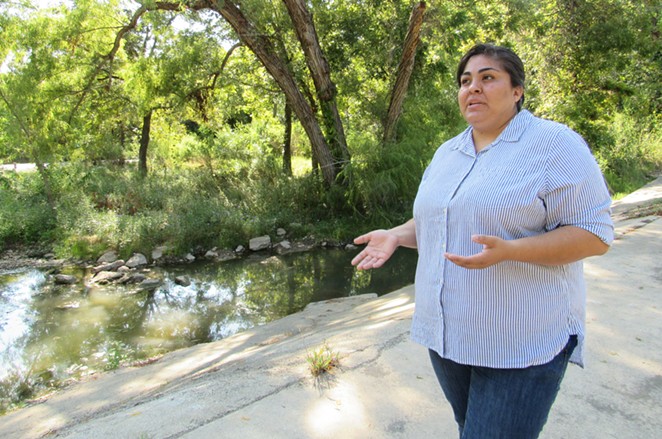 Southwest Workers Union member Sandra Garcia discusses contamination in Leon Creek. - RHYMA CASTILLO