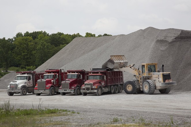 Trucks work at a Vulcan Materials limestone quarry in Tuscumbia, Alabama. - WIKIMEDIA COMMONS / GEORGE F. LANDEGGER