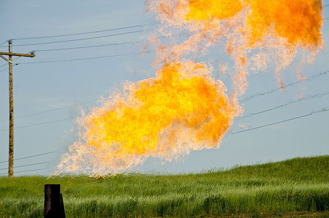 Natural gas burns from the flare-head of an oil well. - TIM EVANSON / WIKIMEDIA COMMONS