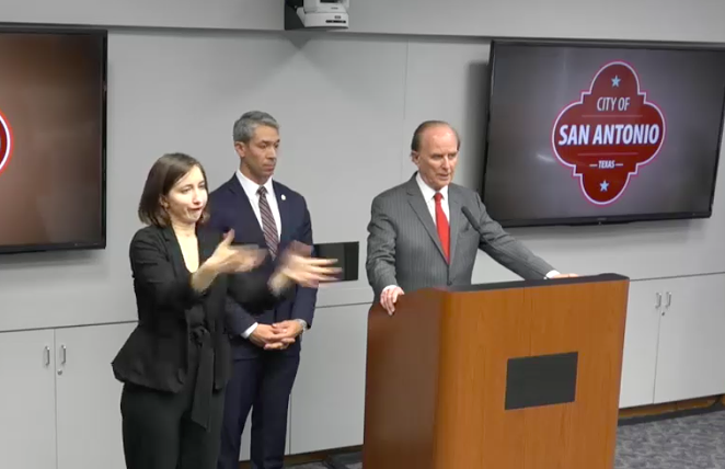 Bexar County Judge Nelson Wolff addresses the press while a sign language interpreter translates. - SCREEN CAPTURE / TVSA