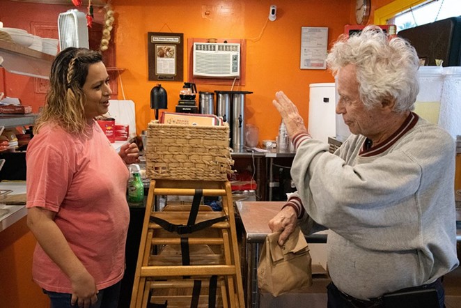 Tom Keene, 85, waves to co-owner Rocio Valdez at Mama’s Kitchen, 504 W. Hildebrand Ave., on Thursday. - V. FINSTER | HERON CONTRIBUTOR