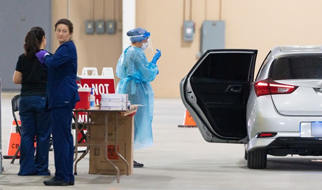 Healthcare workers assist with a drive-through coronavirus test at San Antonio's Freeman Coliseum site. - COURTESY PHOTO / CITY OF SAN ANTONIO