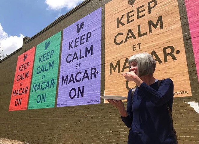 Kathy Sosa eats a macaron in front of the new mural. - TWITTER / SOUTHWEST SCHOOL OF ARRT