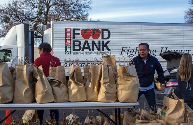 San Antonio Food Bank volunteers help hand out groceries. - INSTAGRAM / SAFOODBANK