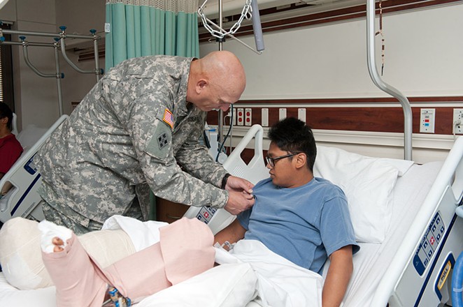 U.S. Army Chief of Staff Gen. Raymond T. Odierno pins a Purple Heart Medal on a wounded soldier at Brooke Army Medical Center in this 2011 image. - WIKIMEDIA COMMONS / STAFF SGT. TEDDY WADE