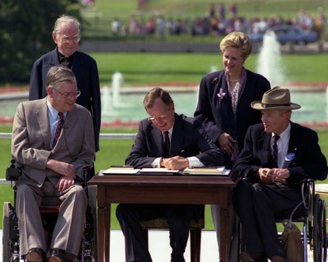 President Bush signs the ADA into law in 1990. - FACEBOOK / ADA NATIONAL NETWORK