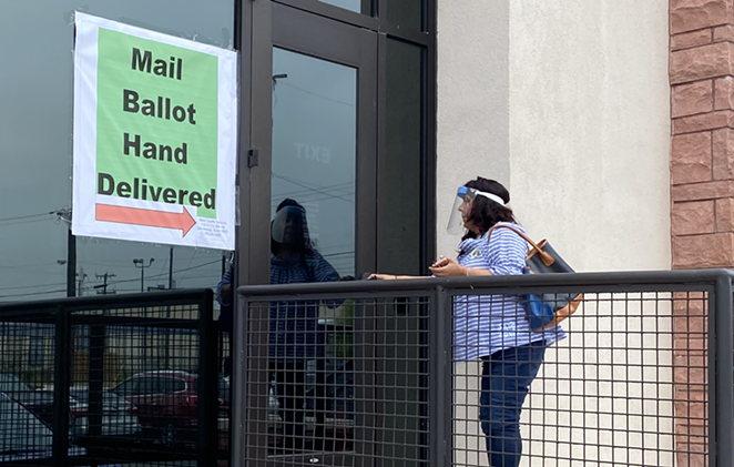 A voter drops off her ballot at the Bexar County Elections Office. - SANFORD NOWLIN