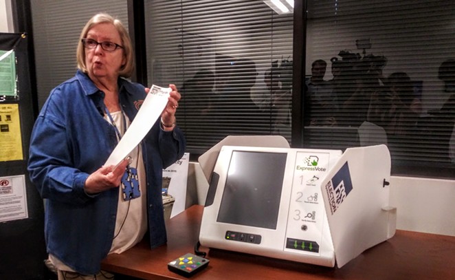 Bexar County Elections Administrator Jacque Callanen demonstrates one of the county's new voting machines during a press event last year. - RHYMA CASTILLO