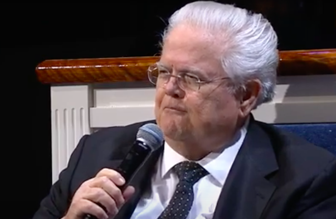 A seated John Hagee tells his flock Jesus healed him of double pneumonia. - YOUTUBE CAPTURE / FRIENDLY ATHIEST