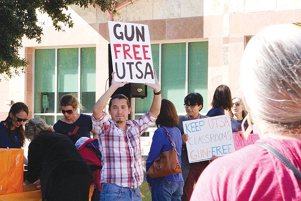 A demonstrator holds up a sign opposing campus carry at UTSA. - GABBY MATA