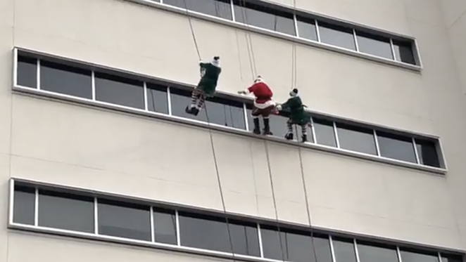 Santa Claus and two elves rappelled down the hospital building to greet children through the windows. - FACEBOOK / METHODIST CHILDREN'S HOSPITAL
