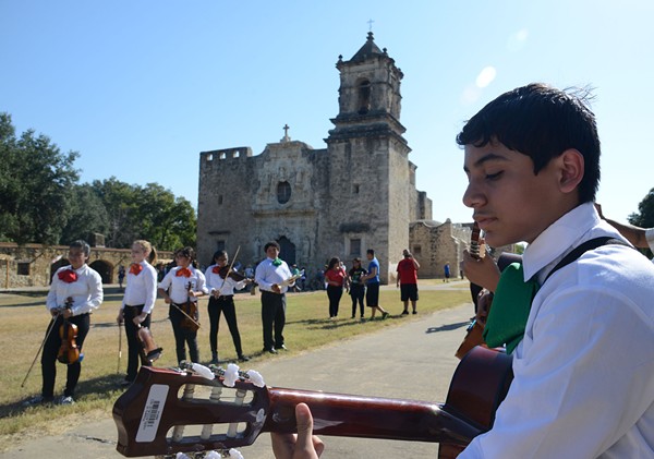 A young guitar player outside Mission San Jose - WIKIMEDIA COMMONS