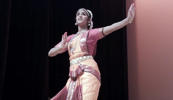 Dance student Gayathri Evani during a bharatanatyam performance in the documentary short Of Gods and Bells. - COURTESY
