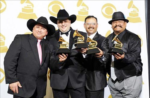 Farias (left) with his Grammy and Los Texmaniacs. - FACEBOOK