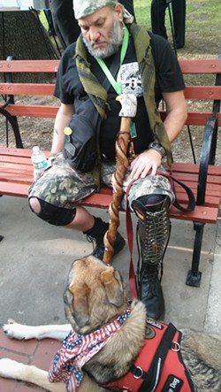 Thomas Riester, a formerly homeless veteran, with his service dog Cooper. Riester receives support for Cooper through Service Dogs Express and Operation at Ease. - Michael Marks