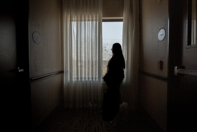Lisa, an anonymous HPV patient living in a Houston hotel to escape domestic abuse, navigates the uncertainties of Planned Parenthood being withdrawn from Medicaid coverage. - BRIANA VARGAS / THE TEXAS TRIBUNE