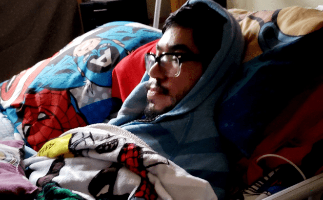 Ralph Garcia, a San Antonio man with muscular dystrophy, and his mother have closed themselves off in his bedroom and packed the window with sblankets to stay warm. - COURTESY PHOTO / DECELERATION