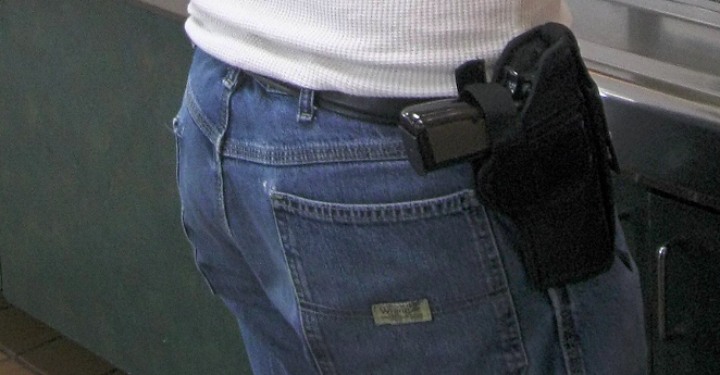 A man open carries a firearm in a fast food restaurant. - Wikimedia Commons / DrunkDriver