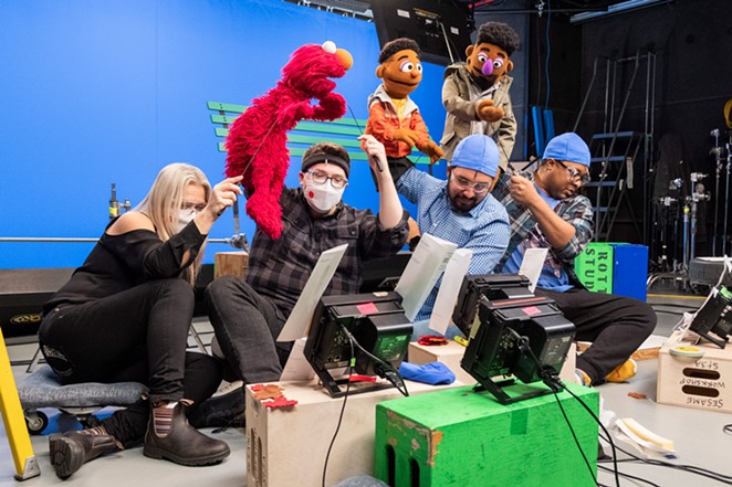 Bradley Freeman Jr. (second from right) controls the  Wesley Walker Muppet during a shoot for a Sesame Street online series. - Sesame Workshop