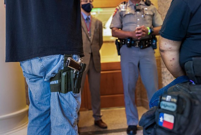 Two gun rights activists argue with a state trooper who will not allow them to enter an overflow room due to COVID-related restrictions at the Capitol on April 29, 2021. - Texas Tribune / Jordan Vonderhaar