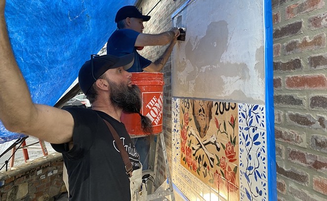 Matt Simpson spreads thin-set onto the wall of Velvet Taco while Mig Kokinda figures out which hand-stenciled tiles go on next. - Sanford Nowlin