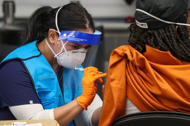A woman receives her COVID-19 vaccination at the city's Alamodome site. - COURTESY / CITY OF SAN ANTONIO