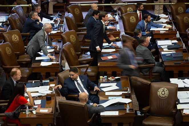 Members of the House move to vote at their desks on the House floor at the state Capitol on May 28, 2021. - TEXAS TRIBUNE / EVAN L'ROY