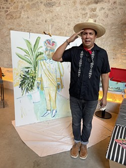Cruz Ortiz poses in front of the completed portrait of Thomas Aguillon. - PHOTO COURTESY CANOPY BY HILTON SAN ANTONIO RIVERWALK