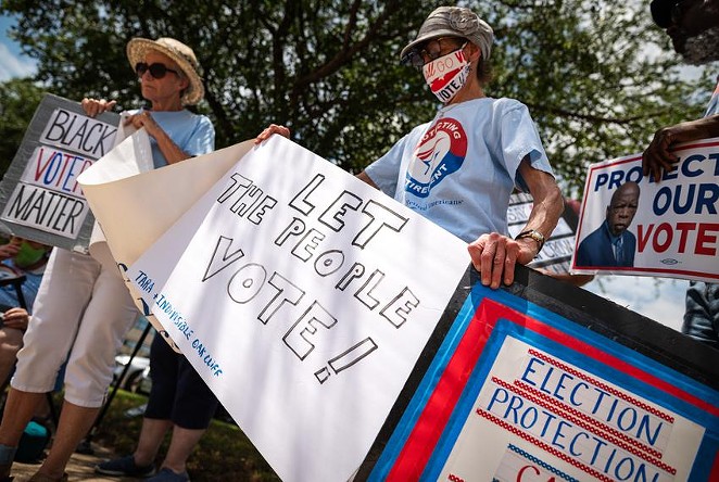 Louise Calvillo and Charolette Connelly, members of the Texas Alliance for Retired Americans, protest against Republicans’ proposed voting restrictions in Richardson. - TEXAS TRIBUNE / BEN TORRES