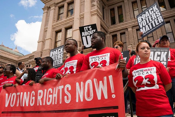 Individuals stand on the south steps of the Texas Capitol in support of voting rights at a press conference organized by Black Voters Matter, the Texas Right to Vote Coalition, Texas for All Coalition and other advocacy groups on July 8, 2021. - Sophie Park / Texas Tribune