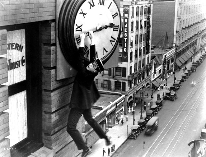 Harold Lloyd hangs from a clock on the side of a skyscraper in the most famous scene from Safety Last! - THE HAROLD LLOYD TRUST