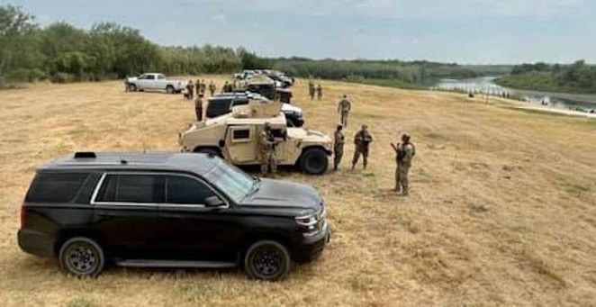 Gov. Greg Abbott touted a cordon of DPS and military vehicles parked along a portion of the Texas border as a "steel wall." - FACEBOOK / GREG ABBOTT