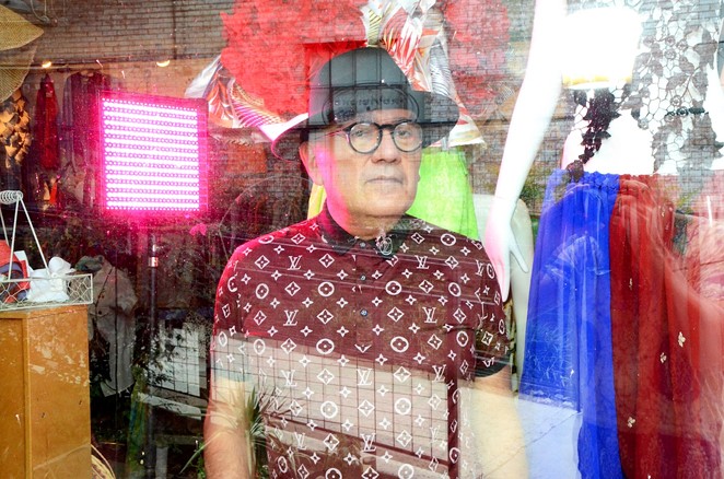 San Antonio designer Agosto Cuellar in the window of his Blue Star boutique Augustine. - BRYAN RINDFUSS